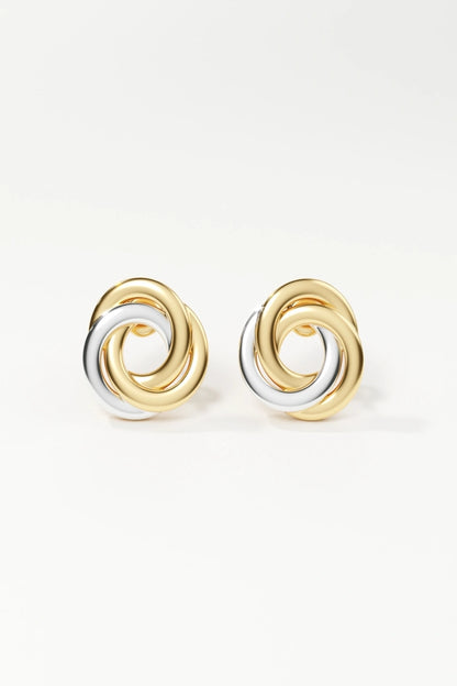 Pair of gold and silver spiral earrings on a white background