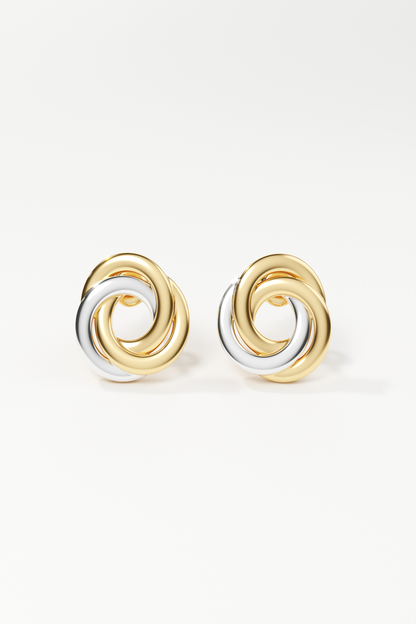 Pair of gold and silver spiral earrings on a white background