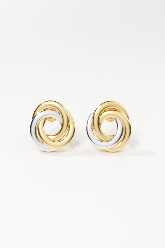 Pair of gold and silver spiral earrings on a white background