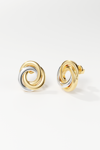 Pair of gold and silver spiral earrings on a white background